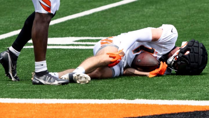 Cincinnati Bengals wide receiver Charlie Jones (15) grabs his knee before being carted off during Cincinnati Bengals practice at Paycor Stadium on Thursday, Aug. 8, 2024.