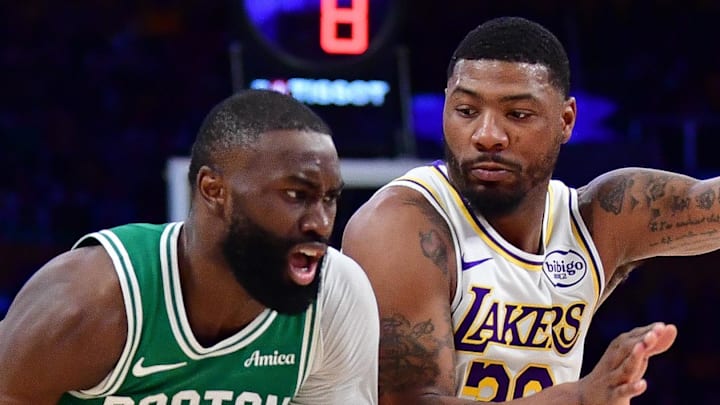 Feb 22, 2026; Los Angeles, California, USA; Boston Celtics guard Jaylen Brown (7) moves to the basket against Los Angeles Lakers guard Marcus Smart (36) and guard Austin Reaves (15) during the first half at Crypto.com Arena. Mandatory Credit: Gary A. Vasquez-Imagn Images