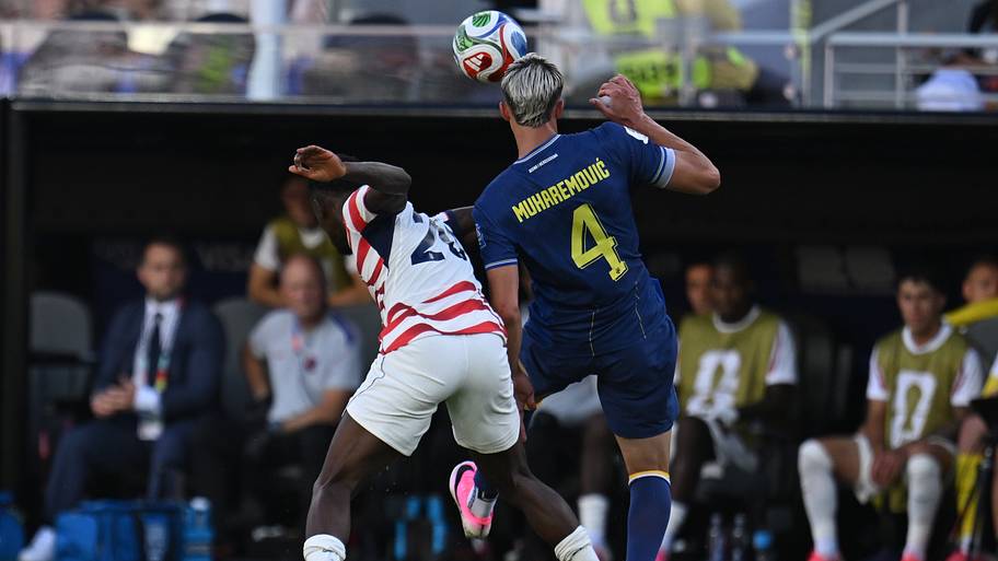 Folarin Balogun (left) crunching into Tarik Muharemović.
