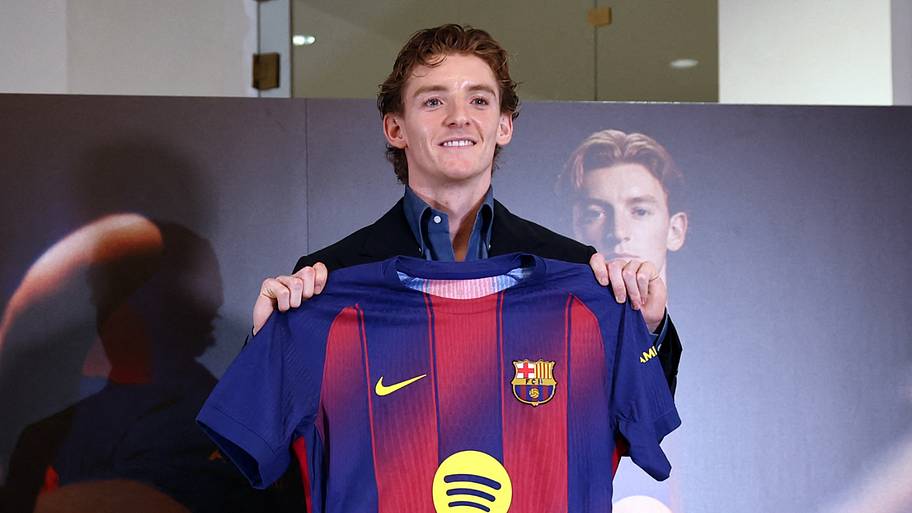 Anthony Gordon proudly holding up his Barcelona jersey.
