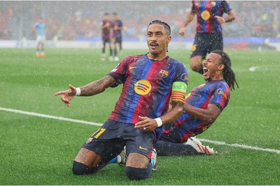 Raphinha celebrates scoring for Barcelona against Feyenoord in the Champions League. 