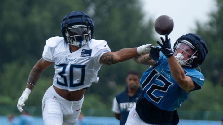 Tennessee Titans defensive back Tay Gowan (30) breaks a pass intended for wide receiver Mason Kinsey (12) during training camp at Ascension Saint Thomas Sports Park Wednesday, Aug. 7, 2024.