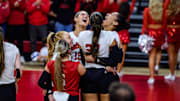 The Huskers celebrate a one-handed, behind-the-court save from Teraya Sigler. The play was part of a 5-0 run that helped Nebraska win the first set.