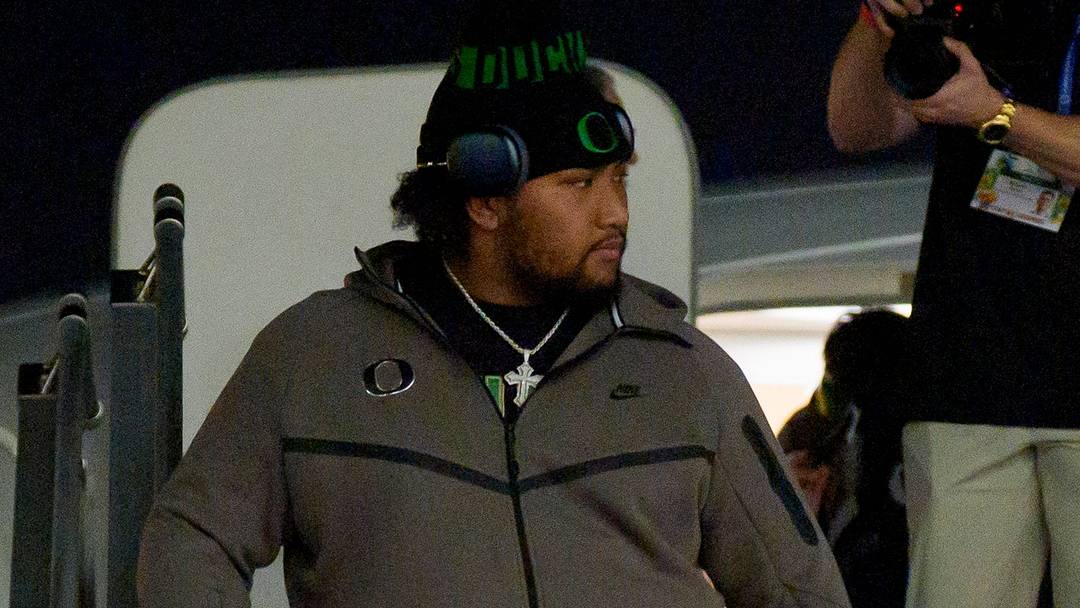 Oregon offensive lineman Iapani Laloulu leads the team off the plane as the Oregon Ducks arrive at Miami International Airport ahead of the Orange Bowl on Dec. 29, 2025, in Miami, Florida.