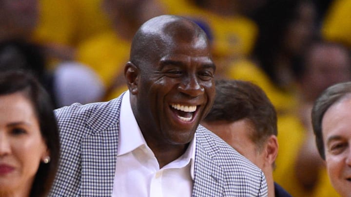June 4, 2015; Oakland, CA, USA; Nicole Curran (left), NBA former player Magic Johnson (center), and Golden State Warriors owner Joe Lacob (right) smile during the second quarter in game one of the NBA Finals against the Cleveland Cavaliers at Oracle Arena. The Warriors defeated the Cavaliers 108-100 in overtime for a 1-0 series lead. Mandatory Credit: Kyle Terada-Imagn Images