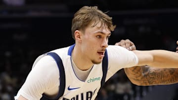 Dallas Mavericks forward Cooper Flagg drives to the basket as Washington Wizards forward Cam Whitmore defends.