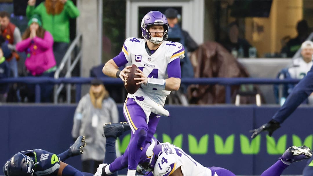 Dec 22, 2024; Seattle, Washington, USA; Minnesota Vikings quarterback Sam Darnold (14) scrambles out of the pocket against the Seattle Seahawks during the fourth quarter at Lumen Field.
