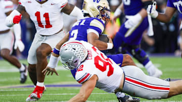 Sep 27, 2025; Seattle, Washington, USA; Ohio State Buckeyes defensive end Caden Curry (92) sacks Washington Huskies quarterback Demond Williams Jr. (2) during the second quarter at Husky Stadium. Mandatory Credit: Joe Nicholson-Imagn Images