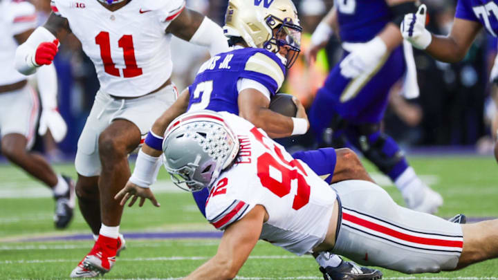 Sep 27, 2025; Seattle, Washington, USA; Ohio State Buckeyes defensive end Caden Curry (92) sacks Washington Huskies quarterback Demond Williams Jr. (2) during the second quarter at Husky Stadium. Mandatory Credit: Joe Nicholson-Imagn Images