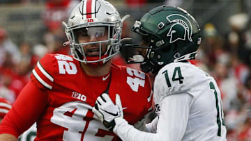 Michigan State Spartans cornerback Khary Crump (14) and Ohio State Buckeyes long snapper Bradley Robinson (42) share words after a punt return.

Syndication The Columbus Dispatch