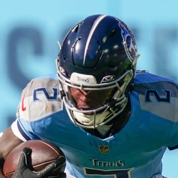 Tennessee Titans running back Tyjae Spears is tackled by Houston Texans linebacker E.J. Speed.
