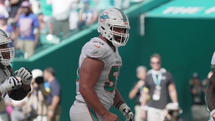 Miami Dolphins running back Chase Edmonds (2) celebrates scoring a touchdown with teammates lineman Connor Williams, center, and Robert Hunt, left, during the fourth quarter of an NFL game at Hard Rock Stadium in Miami Gardens, Sept. 25, 2022.