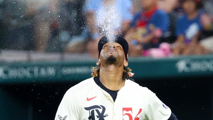 Aug 2, 2024; Arlington, Texas, USA; Texas Rangers starting pitcher Jose Urena (54) spits water into the air before the second inning against the Boston Red Sox at Globe Life Field. Mandatory Credit: Kevin Jairaj-USA TODAY Sports