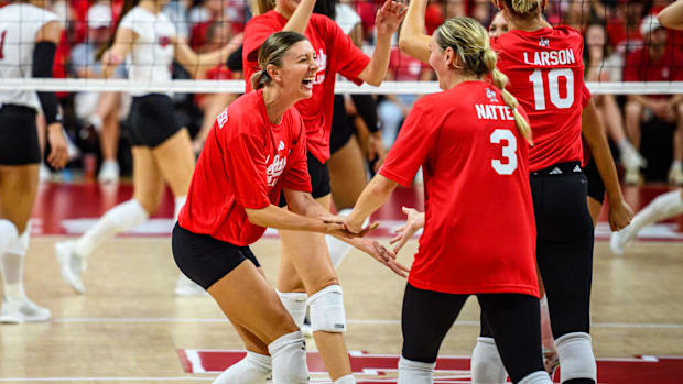 Gina Mancuso-Prososki high fives current assistant coach Kelly Natter (3). 