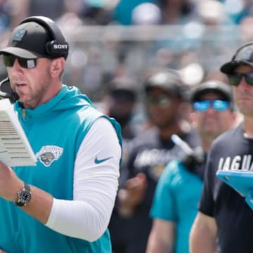 Sep 21, 2025; Jacksonville, Florida, USA; Jacksonville Jaguars head coach Liam Coen reads a play during the second quarter against the Houston Texans at EverBank Stadium. Mandatory Credit: Travis Register-Imagn Images