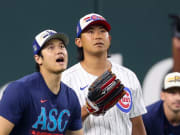 Jul 15, 2024; Arlington, TX, USA; Los Angeles Dodgers pitcher Shohei Ohtani warms up with Chicago Cubs pitcher Shota Imanaga before the 2024 Home Run Derby at Globe Life Field.