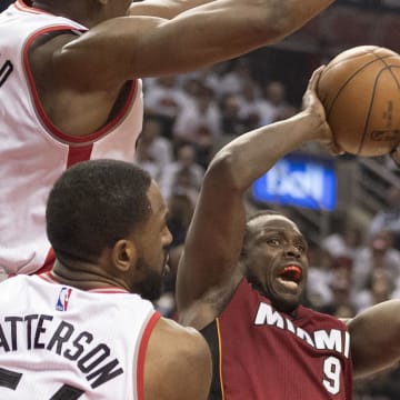 May 15, 2016; Toronto, Ontario, CAN; Miami Heat forward Luol Deng (9) drives to the basket as Toronto Raptors center Bismack Biyombo (8) tries to defend during the second quarter in game seven of the second round of the NBA Playoffs at Air Canada Centre. Mandatory Credit: Nick Turchiaro-USA TODAY Sports