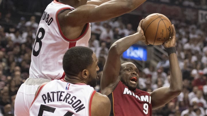 May 15, 2016; Toronto, Ontario, CAN; Miami Heat forward Luol Deng (9) drives to the basket as Toronto Raptors center Bismack Biyombo (8) tries to defend during the second quarter in game seven of the second round of the NBA Playoffs at Air Canada Centre. Mandatory Credit: Nick Turchiaro-USA TODAY Sports