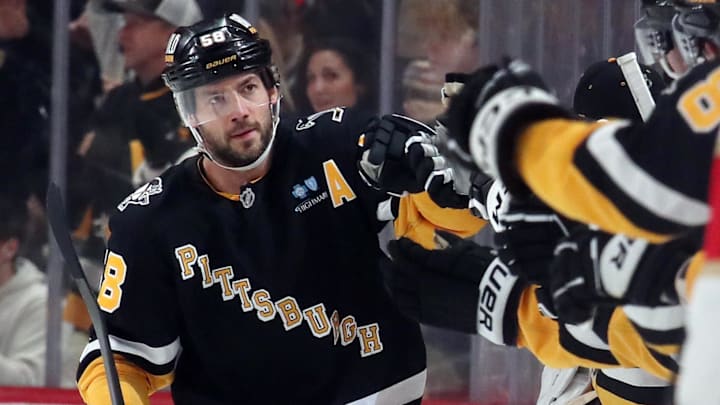Dec 3, 2024; Pittsburgh, Pennsylvania, USA;  Pittsburgh Penguins defenseman Kris Letang (58) celebrates his goal with the bench against the Florida Panthers during the second period at PPG Paints Arena.