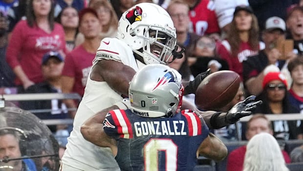 Arizona Cardinals receiver Marvin Harrison Jr. (18) attempts a catch as New England Patriots cornerback Christian Gonzalez (0