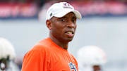 Auburn Tigers safeties coach on the field during a practice.