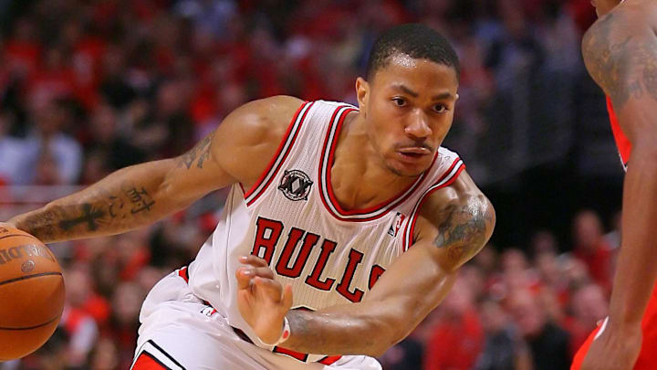 May 10, 2011; Chicago, IL, USA; Chicago Bulls point guard Derrick Rose (left) drives past Atlanta Hawks guard Jeff Teague (0) during the second half in game five of the second round of the 2011 NBA playoffs at the United Center. The Bulls defeated the Hawks 95-83. 