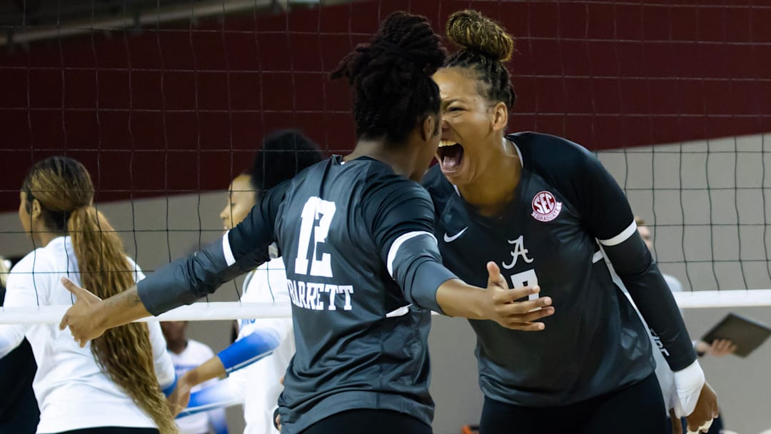 Alabama Crimson Tide volleyball outside hitter Victoria Barrett and  middle blocker Sarah Stevens celebrate after a block against Memphis in the Crimson Classic. 