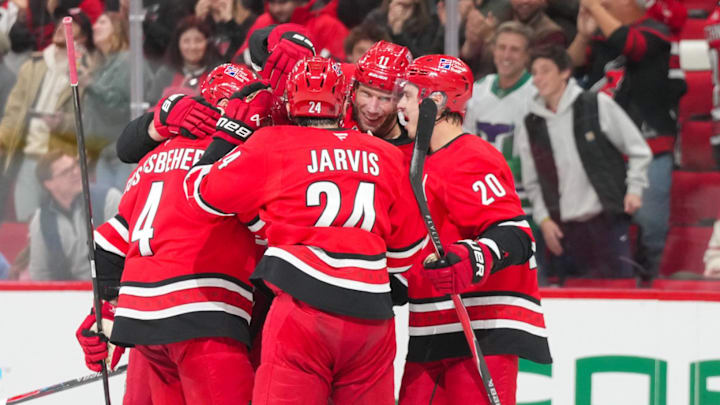 Dec 9, 2025; Raleigh, North Carolina, USA;  Carolina Hurricanes center Jordan Staal (11) is congratulated by  center Sebastian Aho (20) center Seth Jarvis (24) defenseman Shayne Gostisbehere (4) and right wing Andrei Svechnikov (37) after his goal against the Columbus Blue Jackets during the third period at Lenovo Center. Mandatory Credit: James Guillory-Imagn Images