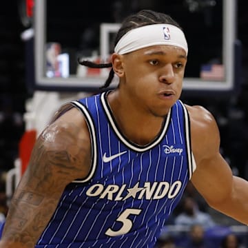 Nov 1, 2025; Washington, District of Columbia, USA; Orlando Magic forward Paolo Banchero (5) drives to the basket as Washington Wizards forward Cam Whitmore (1) defends in the first half at Capital One Arena. Mandatory Credit: Geoff Burke-Imagn Images