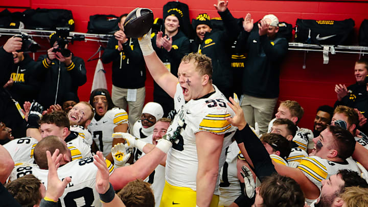 Aaron Graves and his teammates celebrate after Iowa's win over Nebraska Friday.