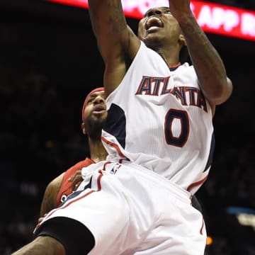 Nov 26, 2014; Atlanta, GA, USA; Atlanta Hawks guard Jeff Teague (0) shoots the ball in front of Toronto Raptors forward James Johnson (3) during the second half at Philips Arena. The Raptors won 126-115. Mandatory Credit: Dale Zanine-USA TODAY Sports