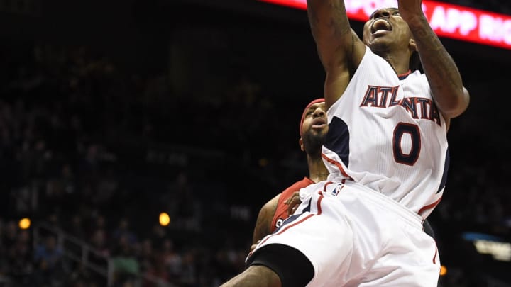 Nov 26, 2014; Atlanta, GA, USA; Atlanta Hawks guard Jeff Teague (0) shoots the ball in front of Toronto Raptors forward James Johnson (3) during the second half at Philips Arena. The Raptors won 126-115. Mandatory Credit: Dale Zanine-USA TODAY Sports