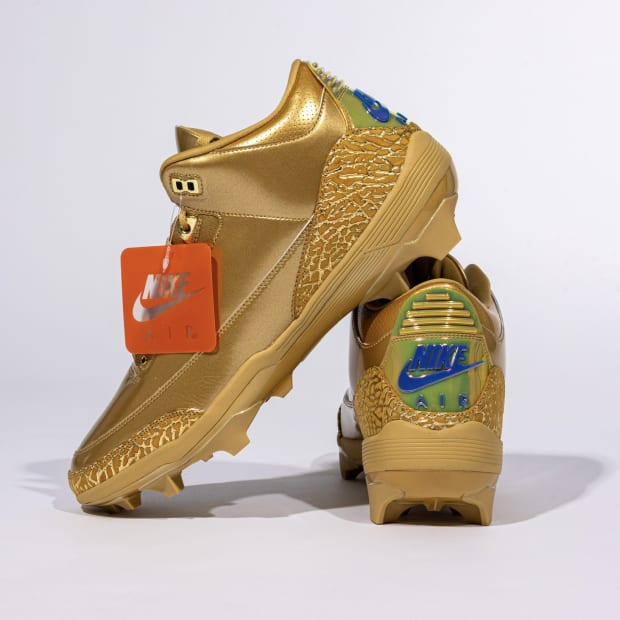 Gold and blue Air Jordan football cleats.