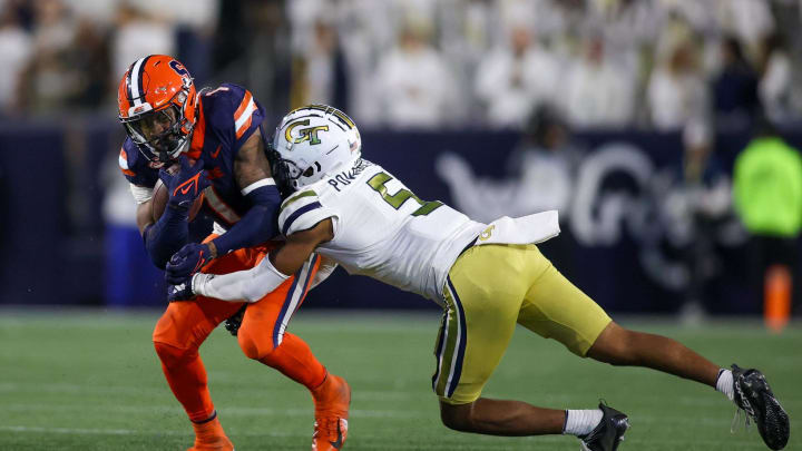 Nov 18, 2023; Atlanta, Georgia, USA; Syracuse Orange running back LeQuint Allen (1) is tackled by Georgia Tech Yellow Jackets defensive back Clayton Powell-Lee (5) in the second half at Bobby Dodd Stadium at Hyundai Field. Mandatory Credit: Brett Davis-USA TODAY Sports