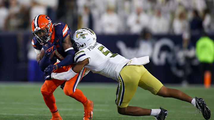 Nov 18, 2023; Atlanta, Georgia, USA; Syracuse Orange running back LeQuint Allen (1) is tackled by Georgia Tech Yellow Jackets defensive back Clayton Powell-Lee (5) in the second half at Bobby Dodd Stadium at Hyundai Field. Mandatory Credit: Brett Davis-Imagn Images