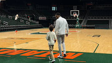 Jai Lucas walking through Watsco Center with his son after his first day with the Miami Hurricanes.