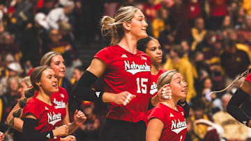 Andi Jackson runs onto the court to celebrate with her teammates after Nebraska finished off a sweep against Minnesota. Jackson led the Huskers with 15 kills.