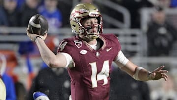 Florida State Seminoles quarterback Luke Kromenhoek (14) looks to throw as he is tackled by Florida Gators defensive back Bryce Thornton (18) during the second half at Doak S. Campbell Stadium.