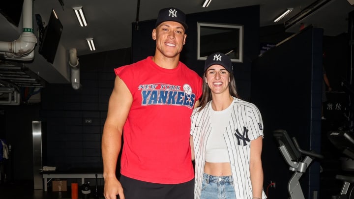 New York Yankees outfielder Aaron Judge poses for a photo with Indiana Fever guard Caitlin Clark.