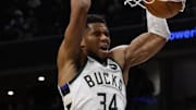 Dec 1, 2025; Washington, District of Columbia, USA; Milwaukee Bucks forward Giannis Antetokounmpo (34) dunks the ball as Washington Wizards forward Khris Middleton (22) looks on in the second quarter at Capital One Arena. Mandatory Credit: Geoff Burke-Imagn Images