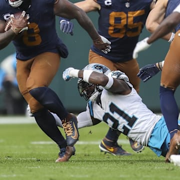 Nov 2, 2025; Green Bay, Wisconsin, USA; Green Bay Packers running back Josh Jacobs (8) slips away from Carolina Panthers safety Nick Scott (21) during the game at Lambeau Field.