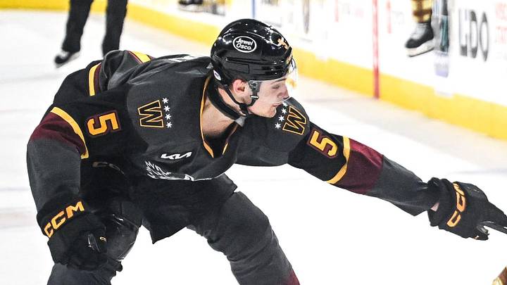 Milwaukee Admirals left wing Navrin Mutter (47) looks for a shot against Chicago Wolves defenseman Charles-Alexis Legault (5) in a game Friday, April 18, 2025, at the UW-Milwaukee Panther Arena in Milwaukee, Wisconsin.