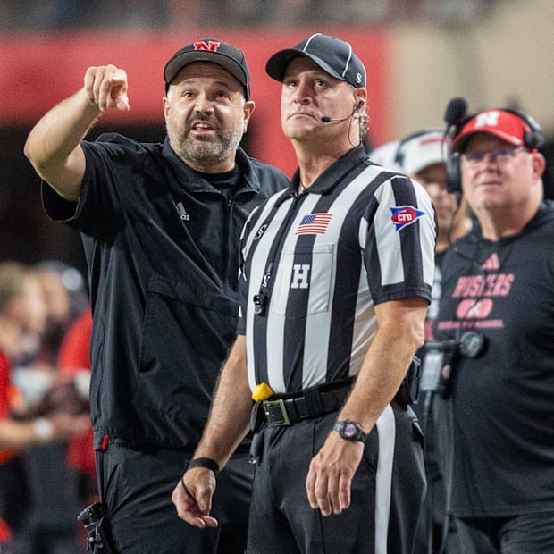 Nebraska Head Coach Matt Rhule points out something on the scoreboard to a referee during the Illinois game.