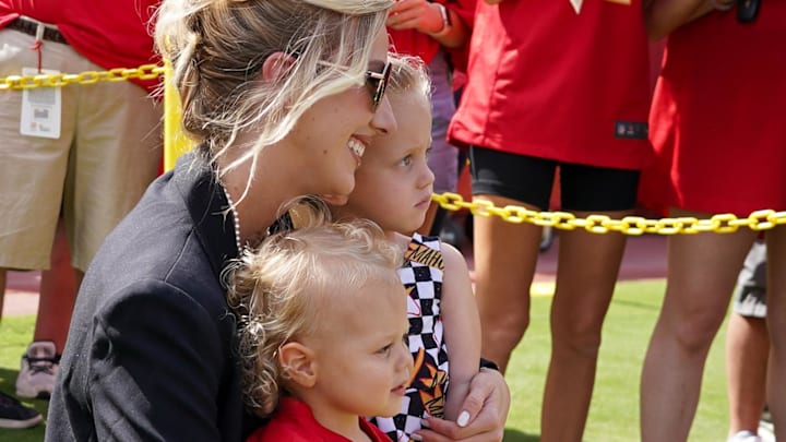 Brittany Mahomes poses with children Bronze and Sterling on field prior to a game between the Kansas City Chiefs and Cincinnati Bengals at GEHA Field at Arrowhead Stadium.