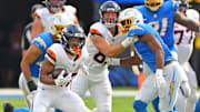 Sep 21, 2025; Inglewood, California, USA; Denver Broncos running back J.K. Dobbins (27) runs the ball during the second half against the Los Angeles Chargers at SoFi Stadium. 