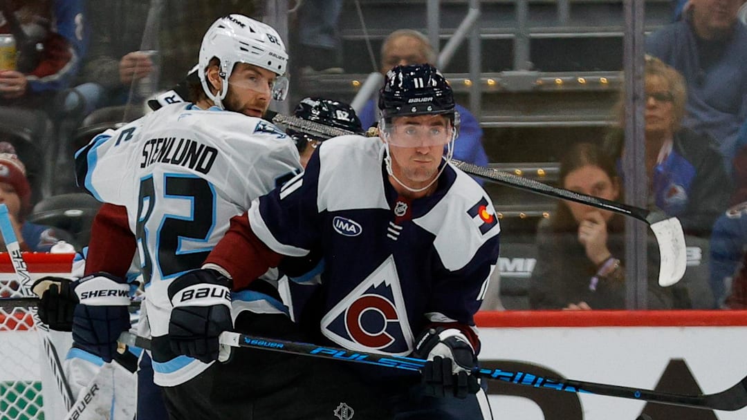 Colorado Avalanche center Brock Nelson (11) and Utah Mammoth center Kevin Stenlund (82)