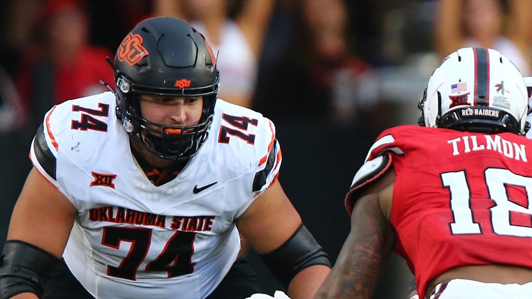 Oklahoma State Cowboys offensive lineman Grant Seagren (74) and offensive lineman Jacob Sanders (75) prepare to block Texas Tech Red Raiders defensive back Terrell Timon (18) in the second half at Jones AT&T Stadium. 