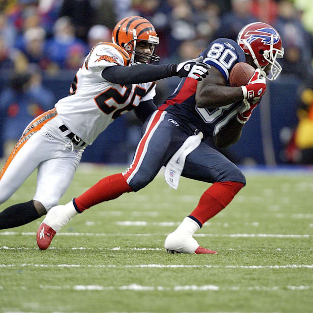 Former Buffalo Bills wide receiver Eric Moulds avoids tackle from Cincinnati Bengals defender.