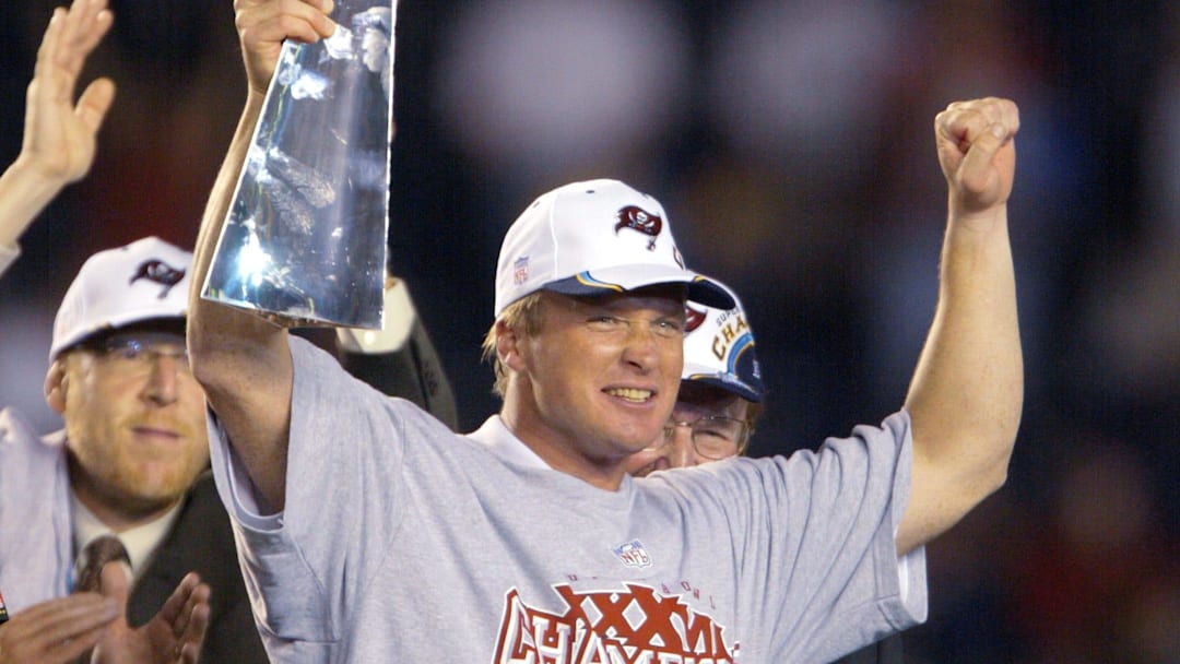 Tampa Bay Buccaneers head coach Jon Gruden holds up the Vince Lombardi Trophy after winning Super Bowl XXXVIII.