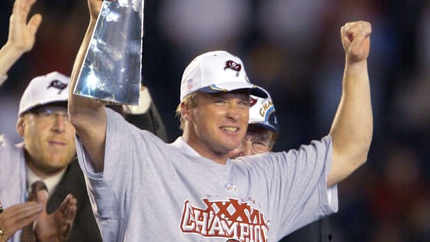 Tampa Bay Buccaneers head coach Jon Gruden holds up the Vince Lombardi Trophy after winning Super Bowl XXXVIII against the Oa
